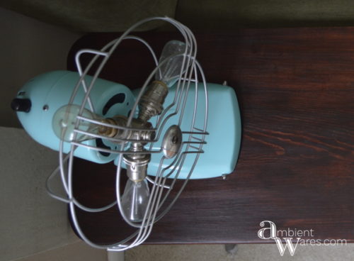 Look at what an old mid-century rusty table top fan can be turned into! For this and more unique ideas, visit AmbientWares.com #fanlamp #uniqueproject #vintagestylelight #rustyfan