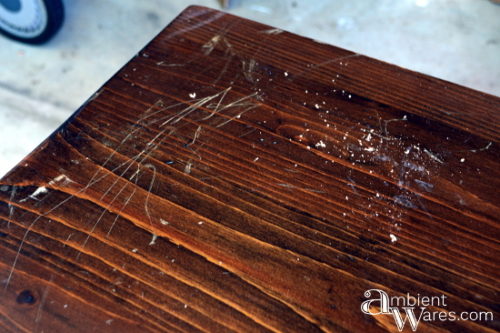 Scratched surface of the TV cart before sanding by AmbientWares.com