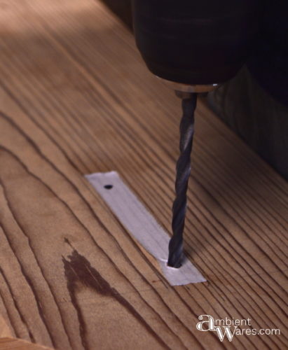 Drilling through the tape for perfect alignment of the hardware screws