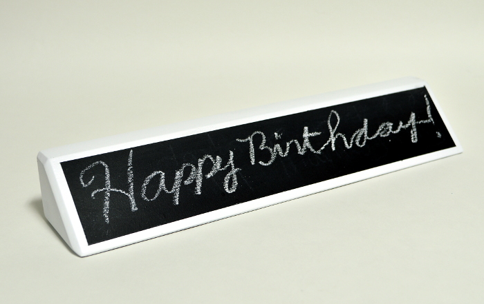 Happy Birthday written on chalkboard name plate