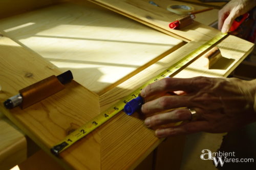 Test fitting old cabinet hardware we'll use to hold the dry erase markers for the DIY organizer