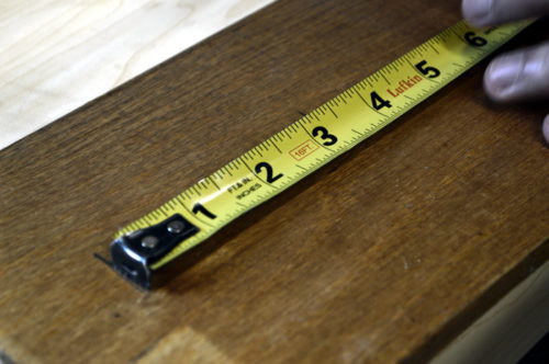 Measuring the wood that will become the planter's lid