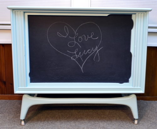 I love upcycled furniture ideas like this one! She transformed an old tube TV shell into the cutest organization station with a chalkboard as well as a shelf for added storage! For this and more unique ideas, visit AmbientWares.com