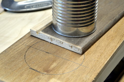 Using a tin can as a stencil for the inner part of the lid