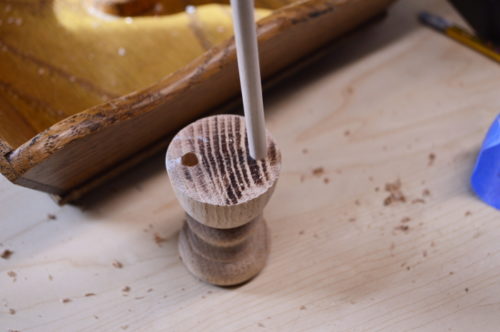 Using craft sticks as dowels to hold the base and the finial together