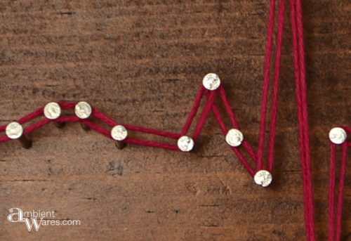 Close up of a heartbeat made with string art by AmbientWares.com