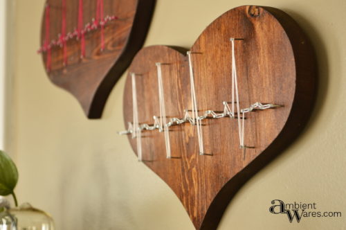 Thrift store wooden hearts get an awesome trash to treasure makeover with string art! AmbientWares.com