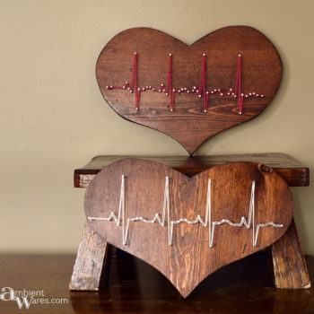 Two thrift store wooden hearts refinished and made to display a heartbeat in string art www.ambientwares.com - www.ambientwares.com