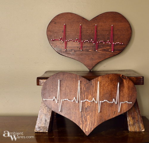 Two thrift store wooden hearts refinished and made to display a heartbeat in string art by AmbientWares.com