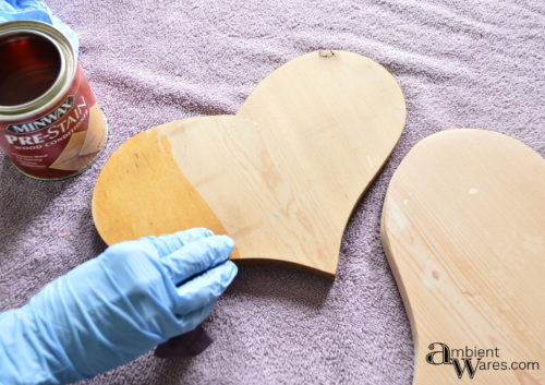 Using wood conditioner on the wooden hearts before staining by AmbientWares.com