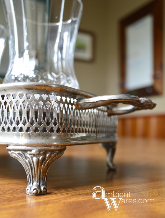 Adding a piece of wood to a silver plated casserol dish along with some thrift store sconces make a great looking centerpiece! For this and more unique ideas, visit, AmbientWares.com