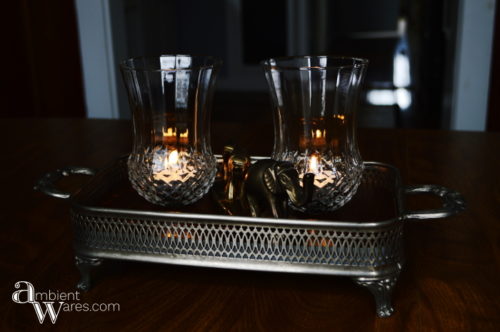 Adding a piece of wood to a silver plated casserol dish along with some thrift store sconces make a great looking centerpiece! For this and more unique ideas, visit, AmbientWares.com