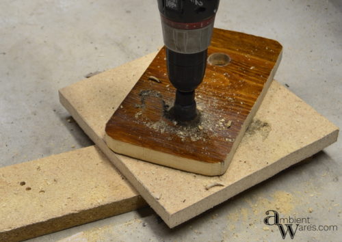 Adding a piece of wood to a silver plated casserol dish along with some thrift store sconces make a great looking centerpiece! For this and more unique ideas, visit, AmbientWares.com