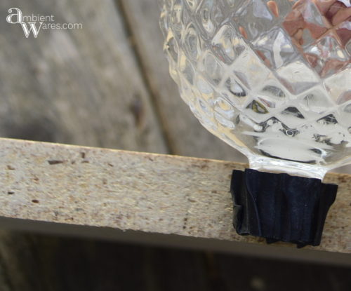 Adding a piece of wood to a silver plated casserol dish along with some thrift store sconces make a great looking centerpiece! For this and more unique ideas, visit, AmbientWares.com