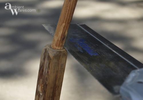 Repurposed_Upside_Down_Stool_Gift_Wrapping_Paper_Ribbon_Station_Sawing_Off_Dowel_ambientwares.com