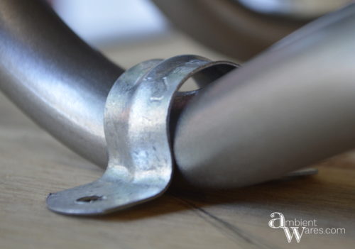 Don't throw away that disgusting plastic chair just yet. Repurpose the metal legs and DIY your own industrial style side table! For this and more unique ideas, visit AmbientWares.com