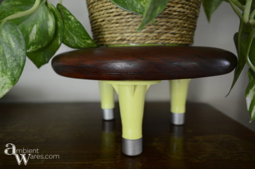 Come see how a wooden seat and old bed frame feet were combined to make a cute mid-century vibed plant stand! For this and more unique project ideas, visit AmbientWares.com!